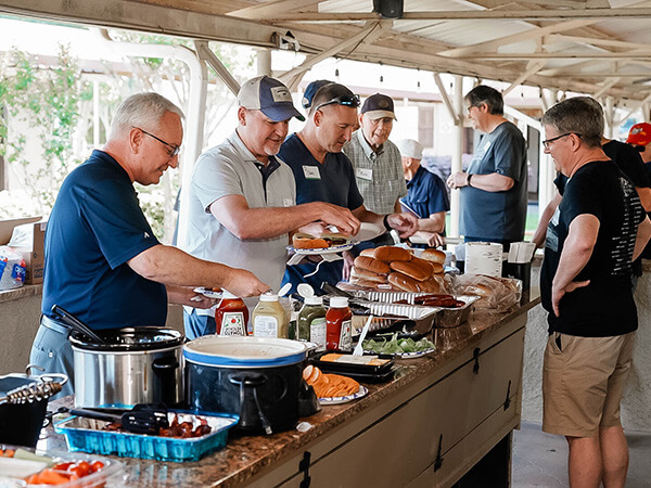 men are eating lunch at the Men's Boot Camp