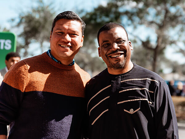 two men pose for a photo