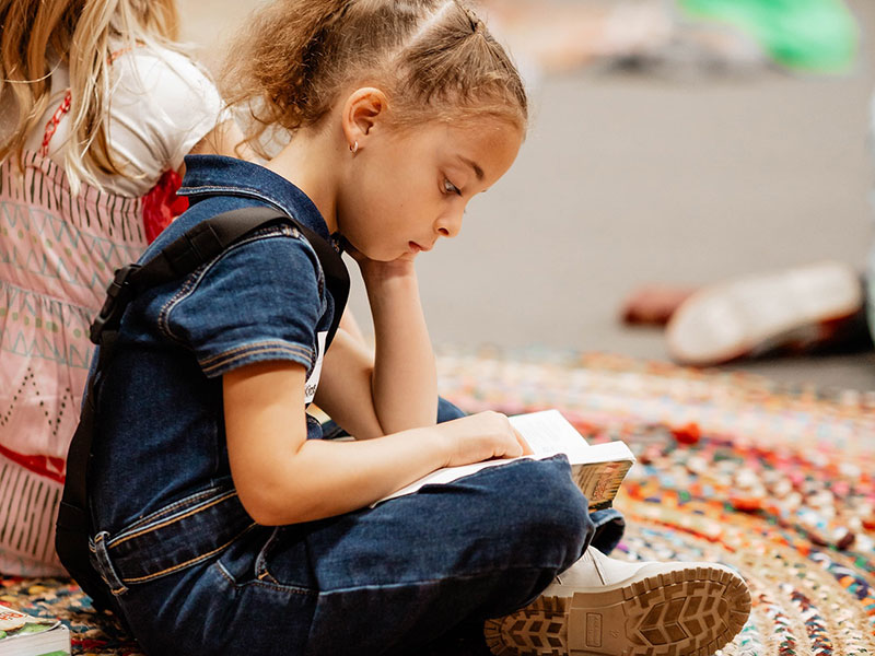 young girl reads her Bible